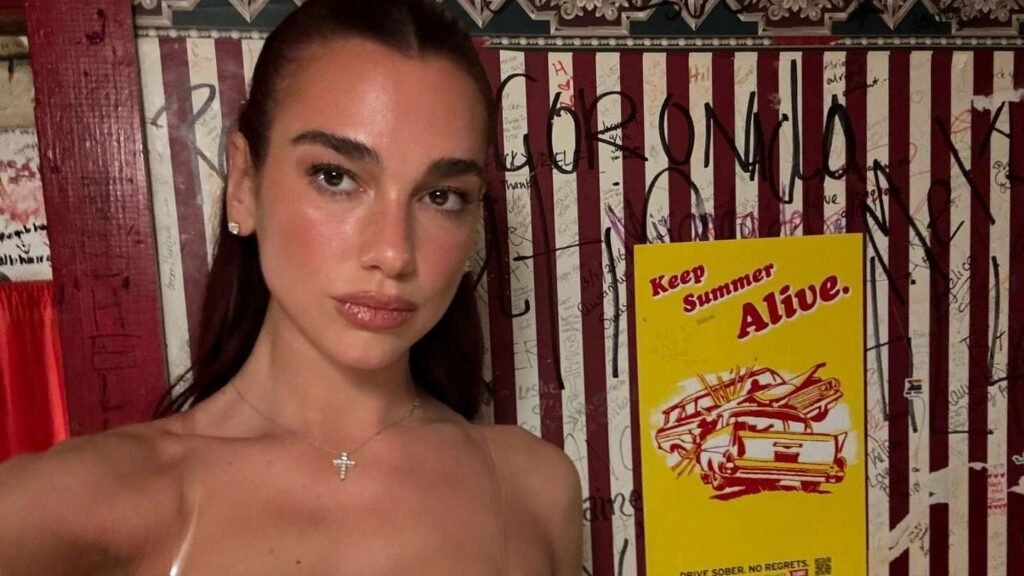 Dua Lipa wears a gold Hello Kitty bra